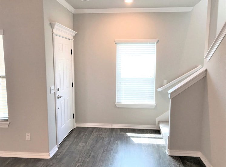 B3 (1-car) Entry with laminate wood flooring facing staircase